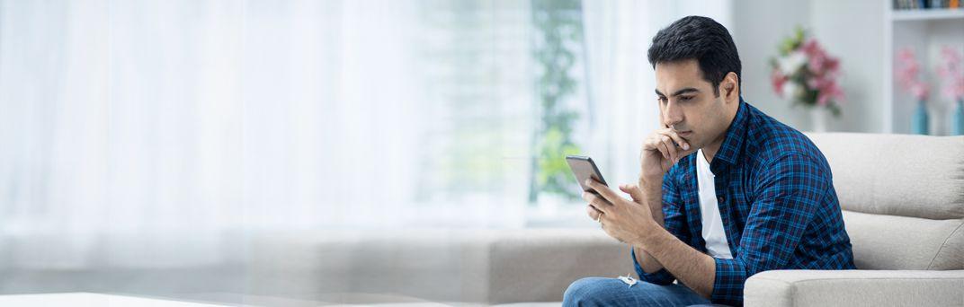 A man uses the Patelco Mobile App to access his bank account details.